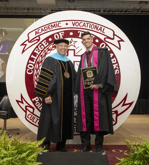 Two people with an award